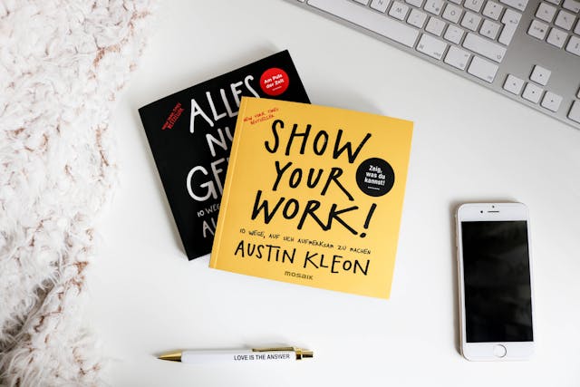 图片中心是一本黄色的书，标题为 Show Your Work